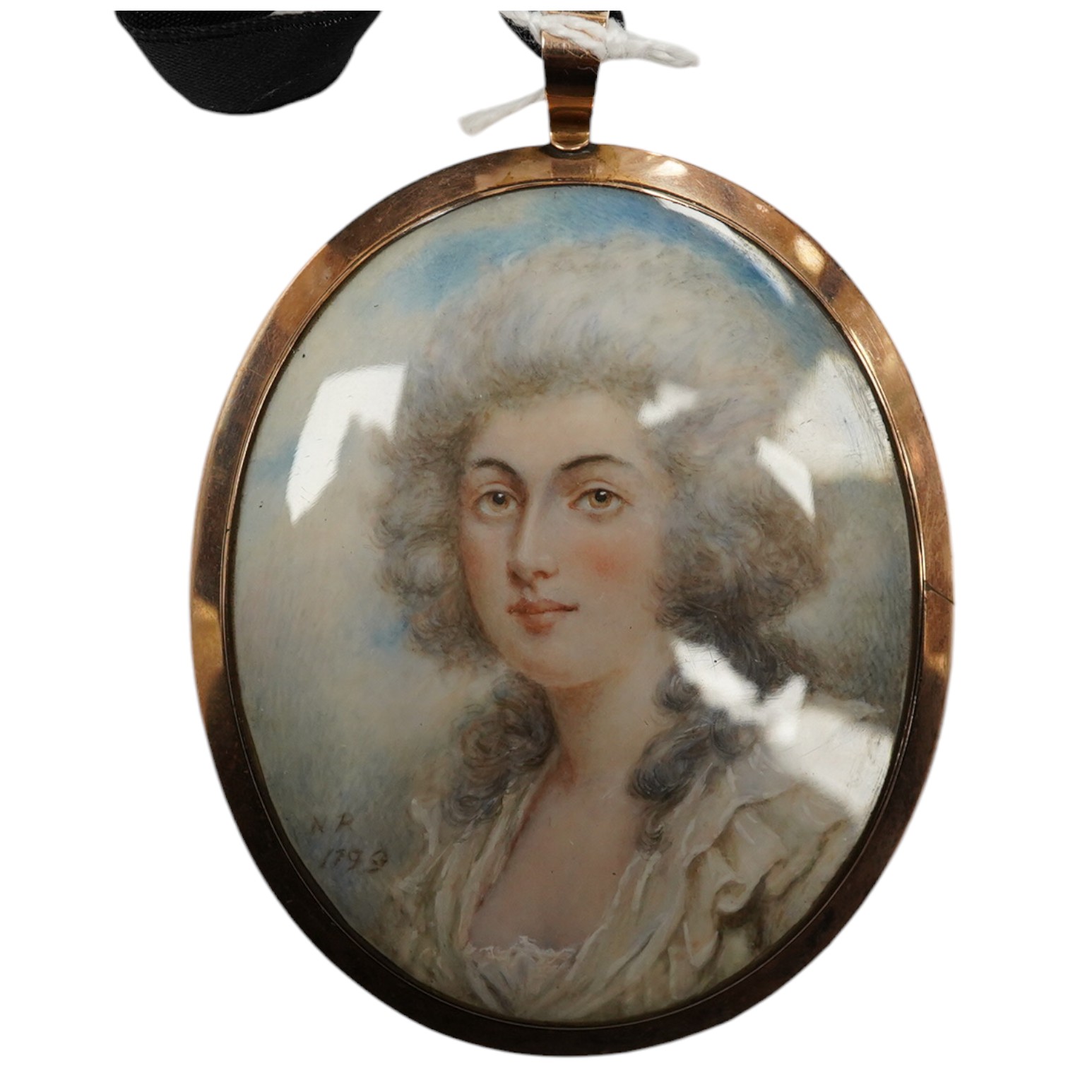 A late 18th century miniature on ivory, Portrait of a lady, initialled NR and dated 1799, lock of hair and seed pearls verso, housed in a yellow metal pendant case, overall 8.2cm x 5.9cm. CITES Submission reference DZHTZ